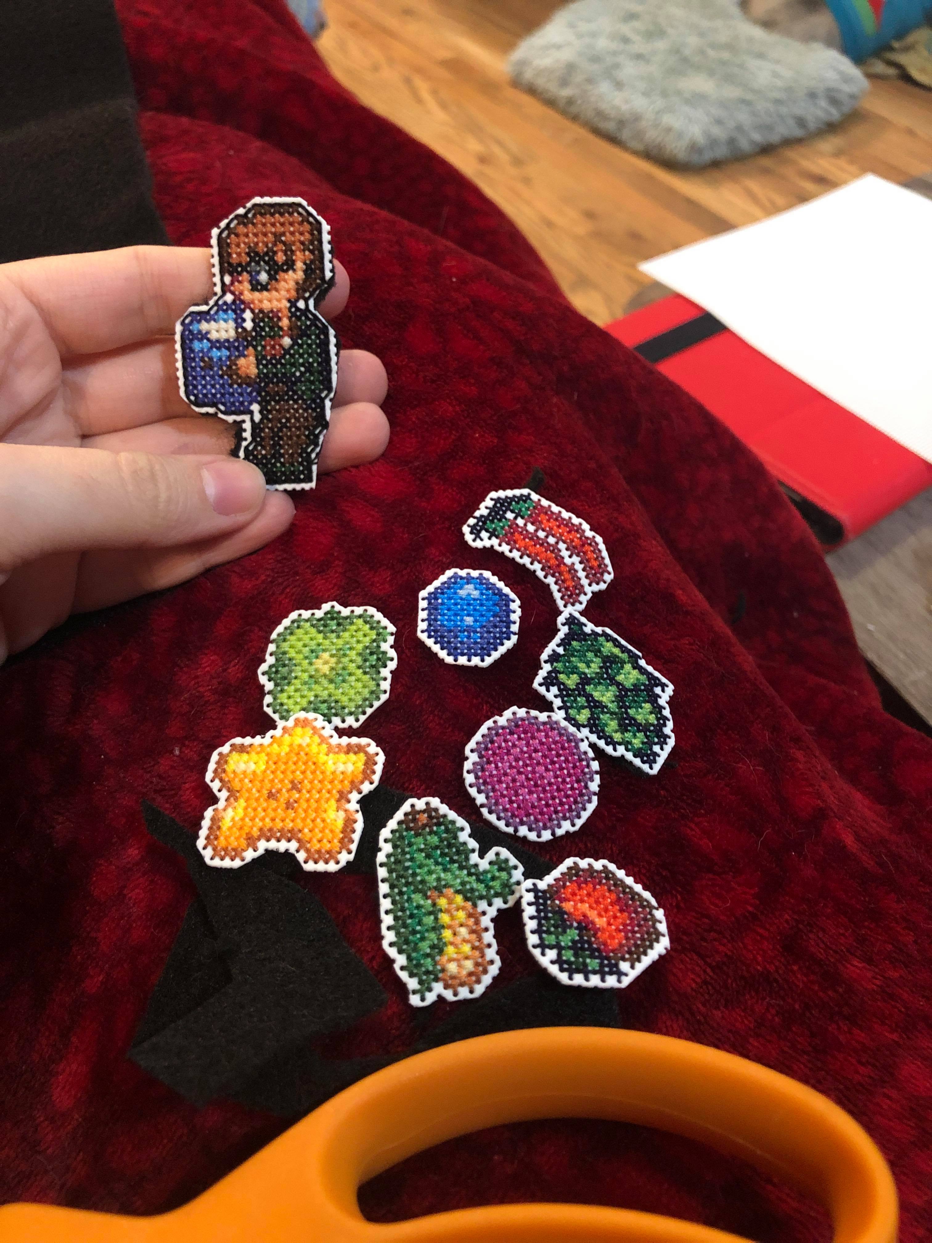 Small cross stitches of various things from stardew valley turned into magnets